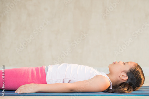 calmness and relax, female freedom happiness. home practice room background. little asian girl meditates while practicing yoga. child happiness. toned picture healthy life. yoga concept.