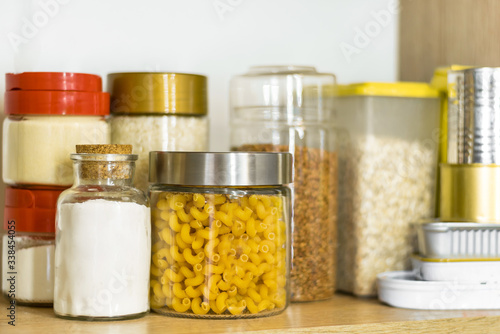 pasta, flour and cereals in glass jars on a shelf