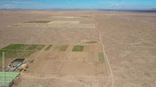 Drone flying over the Kenyan plains and desert. The drone passes a small farm and some fields with crops on. Drone stock footage by DroneRune