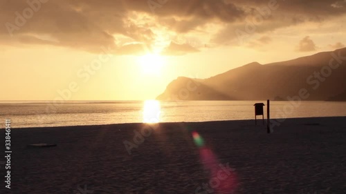 Zoom out shot of a sunset in Figueirinha beach with mountain ridge in the background. photo