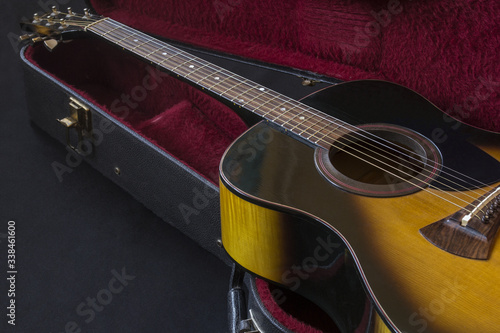 Part of acoustic guitar. Guitar lying in the case