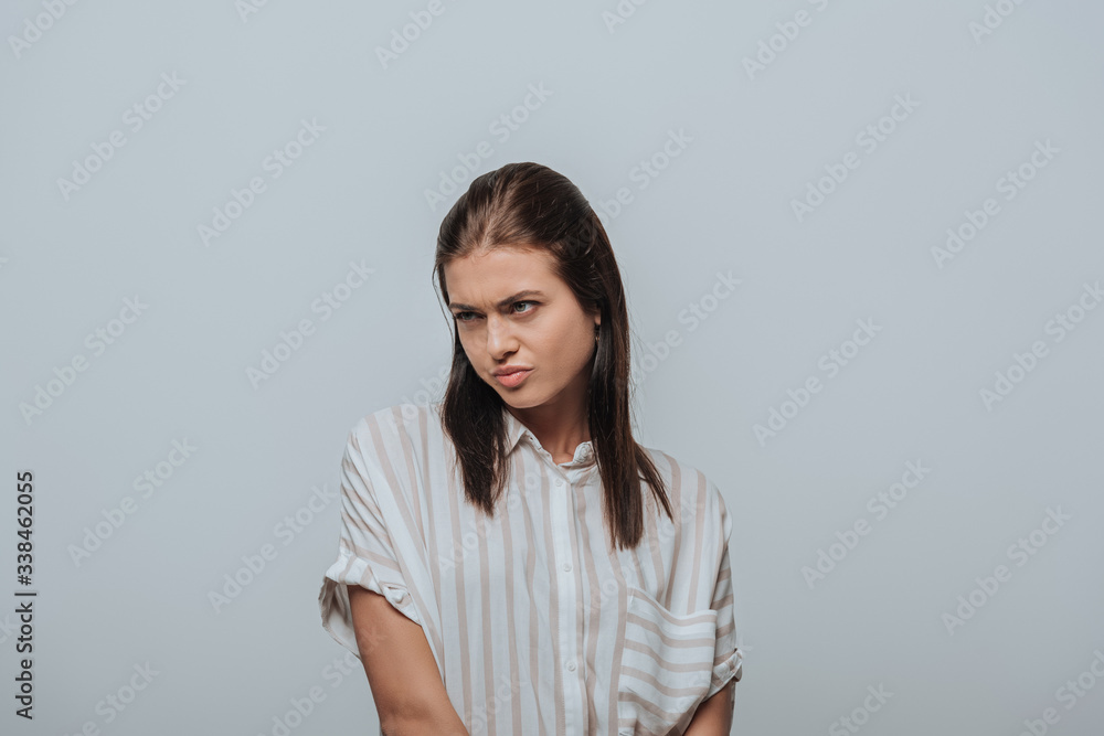 Angry woman looking away isolated on grey Angry woman looking away isolated on grey