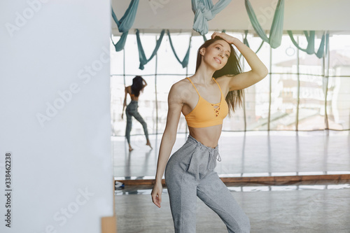 young attractive girl posing at the gym, soft figure, fitness and yoga