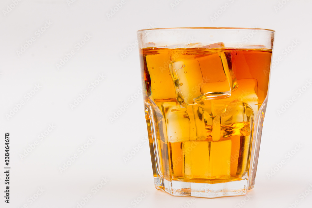 Glass of scotch whiskey and ice over white background. Glass of scotch whiskey and ice over white background.