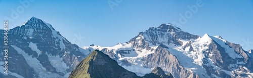 Fototapeta Naklejka Na Ścianę i Meble -  Switzerland, Panoramic view on Eiger, Monch and Jungfraujoch and green Alps around