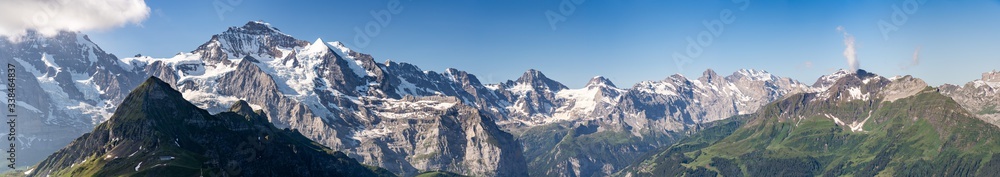 Switzerland, Panoramic view on Eiger, Monch and Jungfraujoch and green Alps around Switzerland, Panoramic view on Eiger, Monch and Jungfraujoch and green Alps around