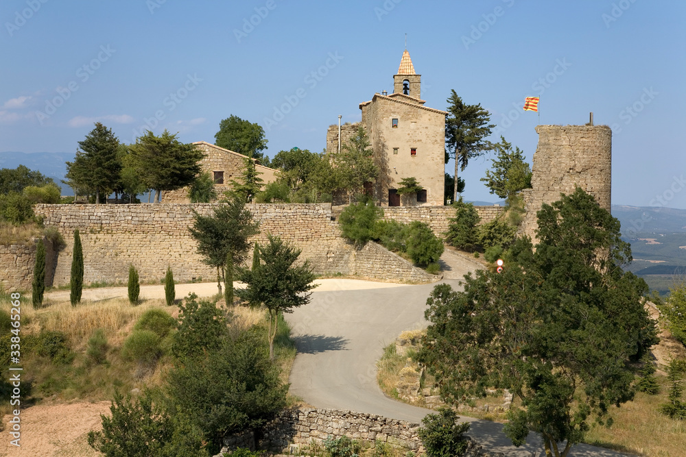 Historic castle flying Spanish flag near village of Solsona, Cataluna, Spain