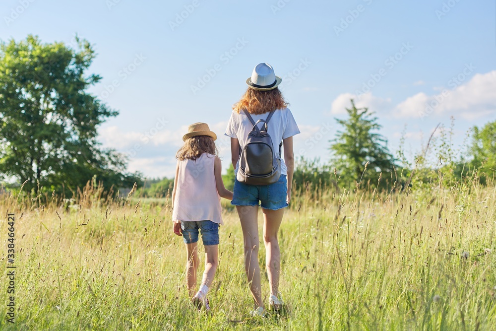 Fototapeta premium Summer vacation, children two girls sisters walking together holding hands