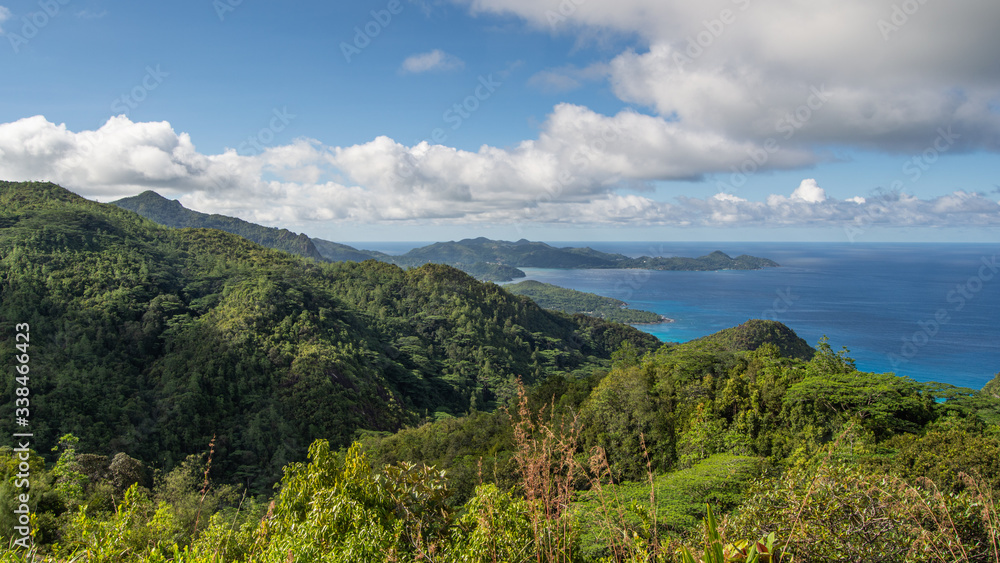 A tropical Mountain Landscape was taken from the top of one of the mountains on the island of Mahe in Seychelles.  This is from the north part of the island looking out into the Indian Ocean.
