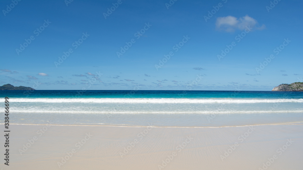 This is a tropical landscape taken from the Island of Mahe in Seychelles. The pristine white tropical sandy beach leading out into the Indian Ocean. This is a tropical landscape taken from the Island of Mahe in Seychelles. The pristine white tropical sandy beach leading out into the Indian Ocean.