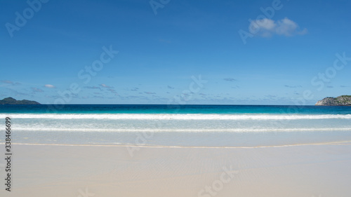 This is a tropical landscape taken from the Island of Mahe in Seychelles.  The pristine white tropical sandy beach leading out into the Indian Ocean.