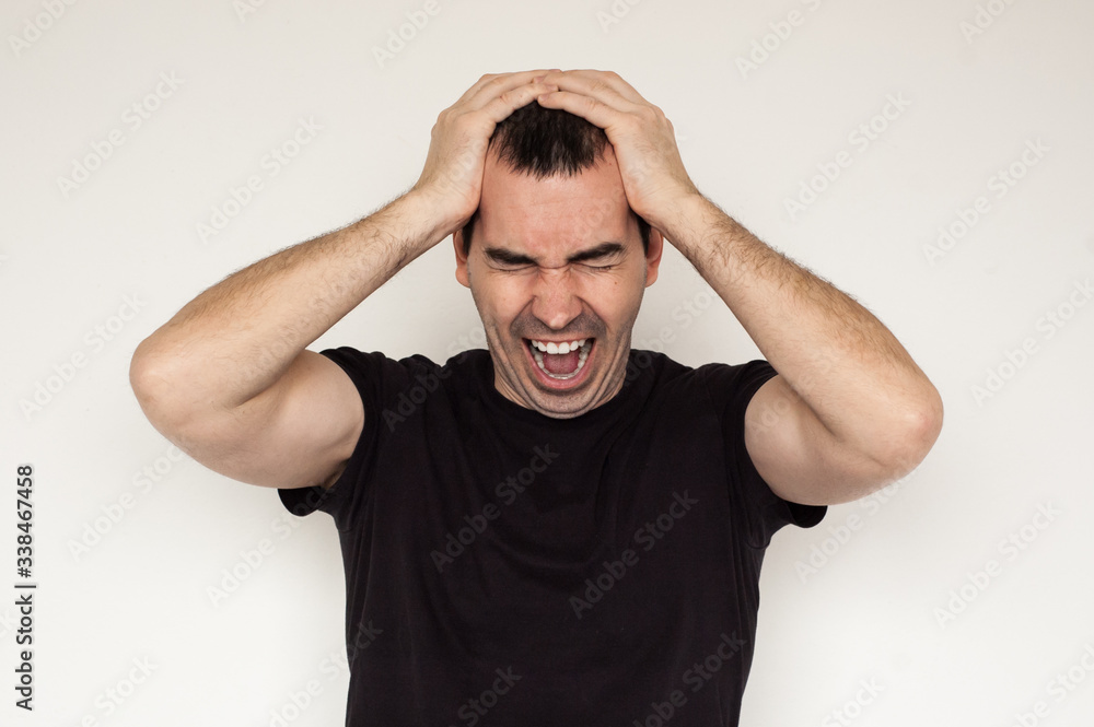 Fototapeta premium white male man migraine headache black tshirt closeup hands white background painful