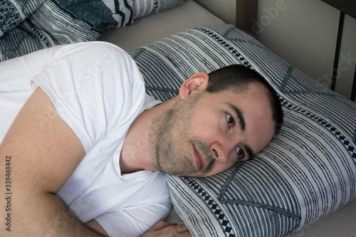 man lie on bed pillow open eyes, can not sleep. Insomnia.Symptoms and causes. Sleeping Difficulty. Signs That Your Sleep Quality Is Poor. Disorders and Problems. Sleeping Difficulty Causes, Diagnosis