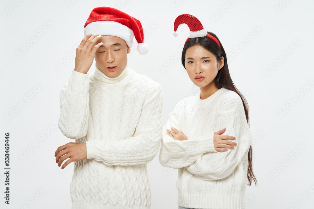 Fototapeta premium young couple in santa hats
