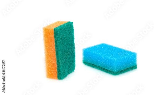 Two sponges of orange and blue for washing dishes. Isolated object on a white background. Means for cleaning the house.
