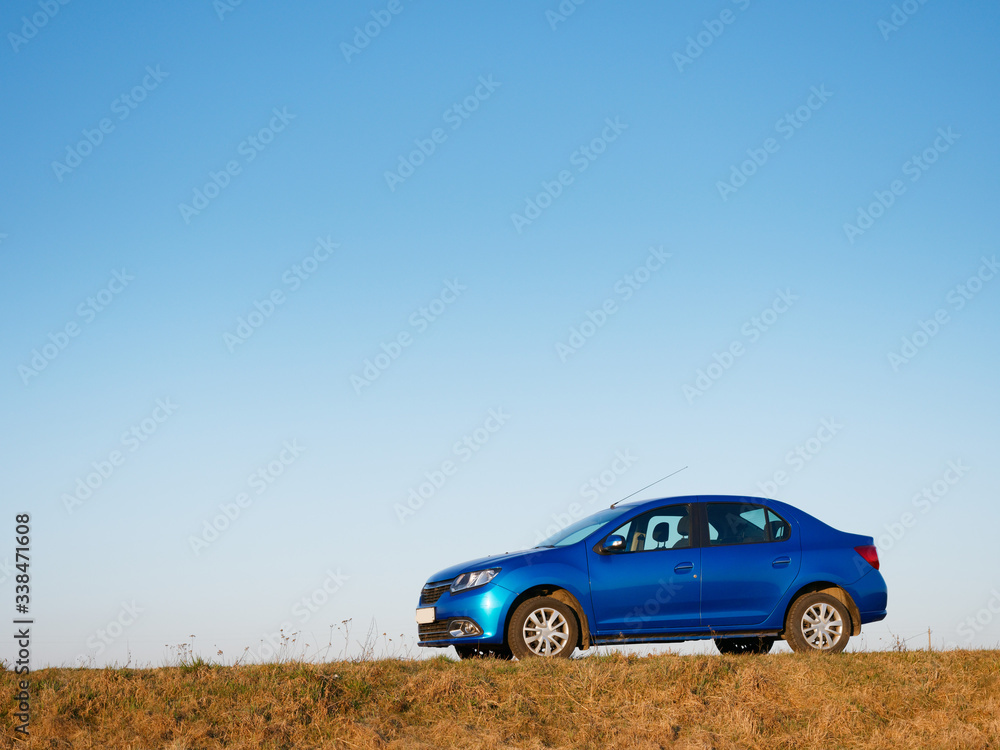 Belarus blue car in a field in spring at sunrise Belarus blue car in a field in spring at sunrise