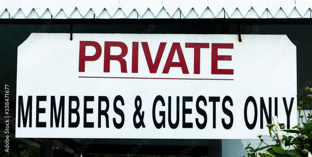 Private sign members and guests only hanging at entrance to club