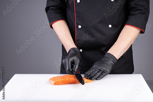 
slicing fresh salmon for sushi in a restaurant3 photo