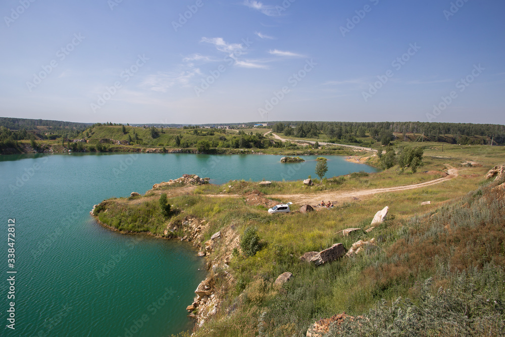 Flooded open pit quarry with blue water lake Flooded open pit quarry with blue water lake