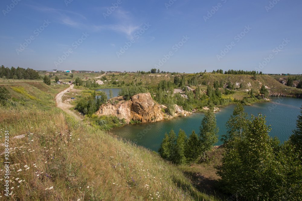 Flooded open pit quarry with blue water lake Flooded open pit quarry with blue water lake