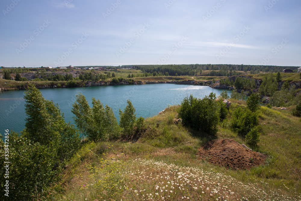 Flooded open pit quarry with blue water lake Flooded open pit quarry with blue water lake
