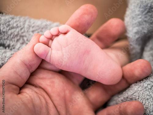 Parent is holding newborn baby little feet