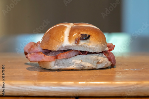 British Easter breakfast sandwich of bacon on a hot cross bun