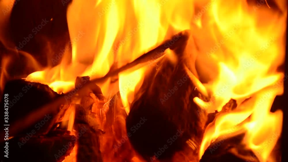 the wood burning in the fireplace. bright bursts of coals the wood burning in the fireplace. bright bursts of coals