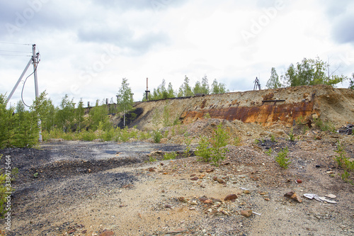 Dull landscape on abandoned mining site with surface dump photo