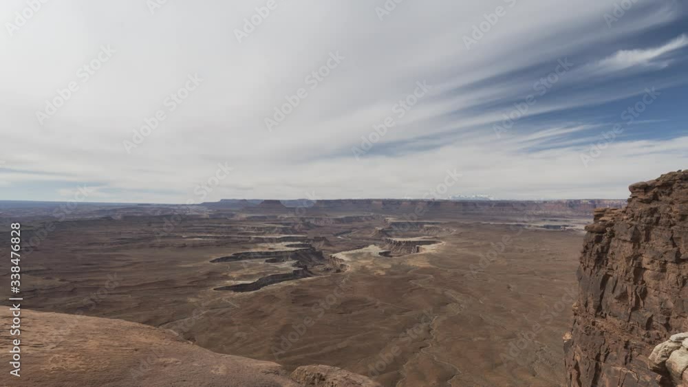A wide timelapse lookout out from Green River Overlook at Canyonlands National Park towards the Green River canyon far below. Clouds flow overhead. A wide timelapse lookout out from Green River Overlook at Canyonlands National Park towards the Green River canyon far below. Clouds flow overhead.