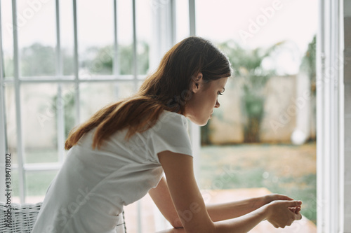 young woman looking out window Free Download young woman looking out window - GFXLoad