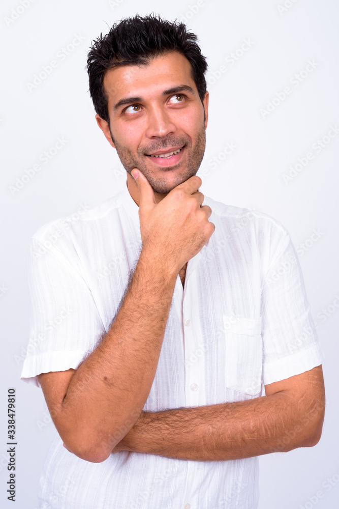 Portrait of happy handsome Turkish man thinking Portrait of happy handsome Turkish man thinking