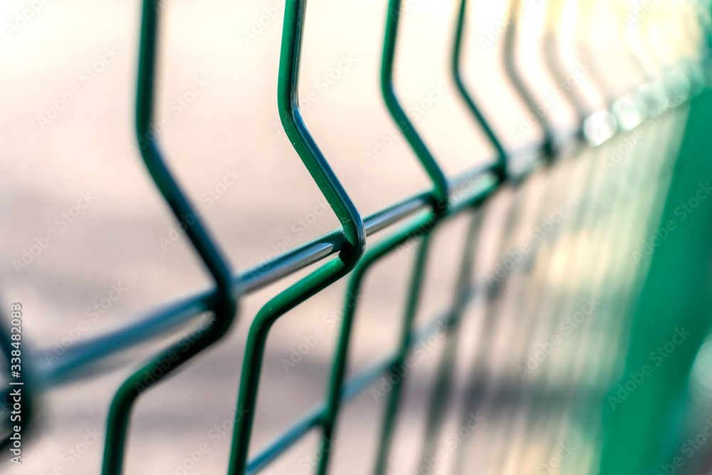 Metal fence close-up. Territory fencing, green fence. Metal fence close-up. Territory fencing, green fence.
