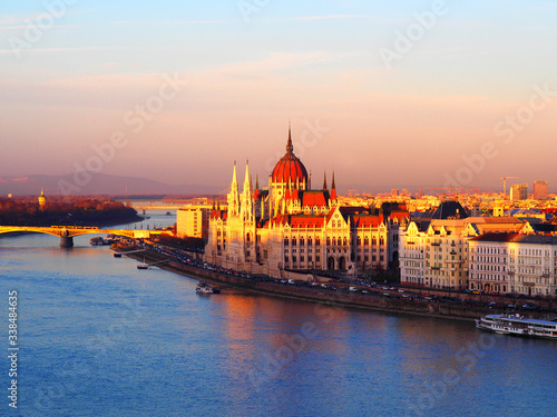 View of the Hungarian Parliament Building and the Danube river at sunset in Budapest, Hungary. © miff32