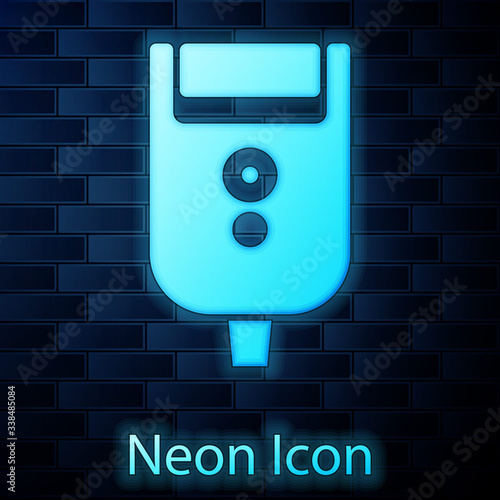 Glowing neon Electric razor blade for men icon isolated on brick wall background. Electric shaver.  Vector Illustration