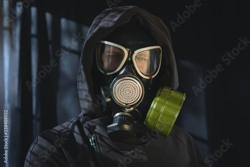 Portrait of a man in a full-face protective mask, a military gas mask with a wilt box. Respiratory protection from harmful substances, chemical and biological weapons, corrosive chemicals.
