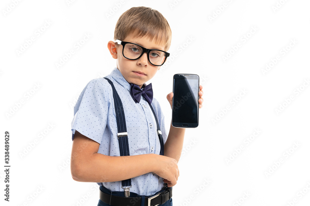 Kind young caucasian teenager shows his new smartphone on white background