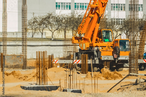 Machine crane, at a construction site, concrete structures