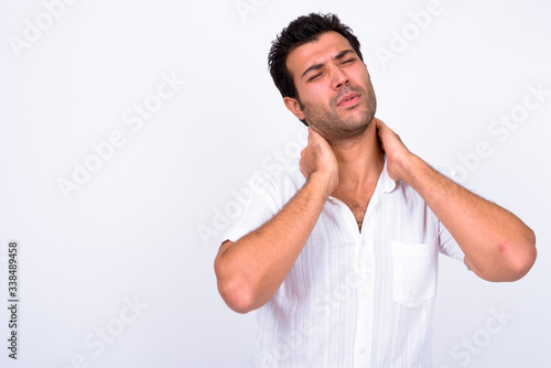 Portrait of stressed Turkish man having neck pain