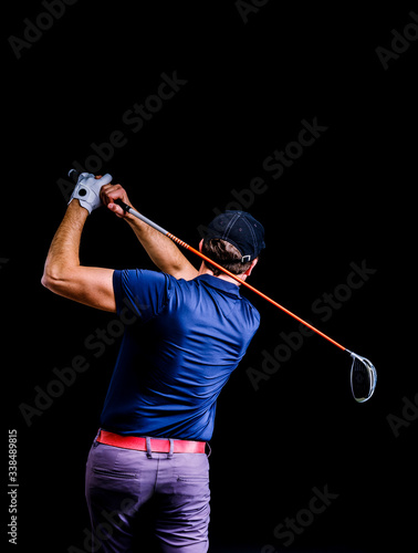 Close-up of a golf player intent on perfecting the swing isolated on dark background. Vertical image