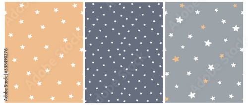 Cute Abstract Starry Sky Seamless Vector Patterns. White Freehand Stars on a Gray, Graphite and Pale Orange Background. Simple Infantile Style Irregular Print with Funny Hand Drawn Stars.