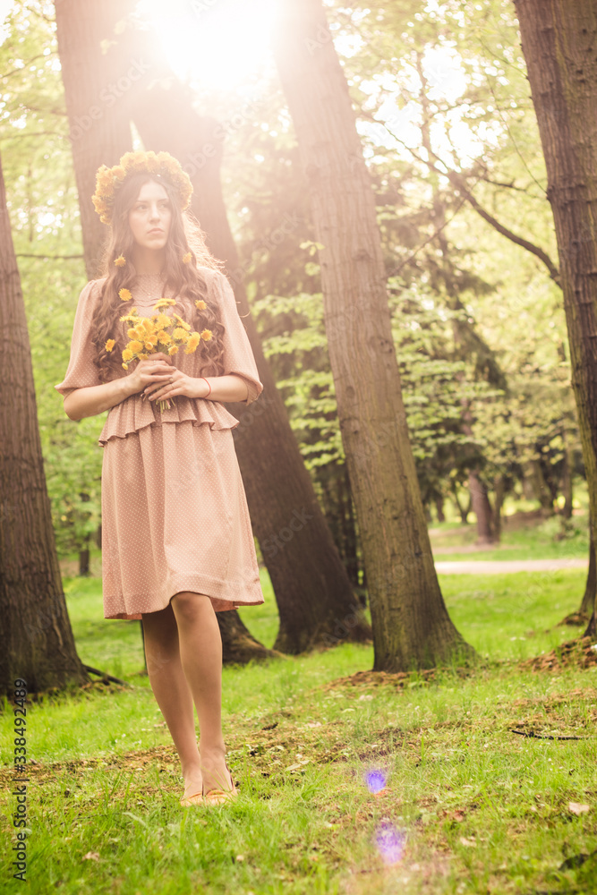 Fashion Summer Model Girl with Long Blowing Hair. Summer Beautiful Woman with Healthy and Beauty Brown Hair with Green Grass on Sunny Background Fashion Summer Model Girl with Long Blowing Hair. Summer Beautiful Woman with Healthy and Beauty Brown Hair with Green Grass on Sunny Background