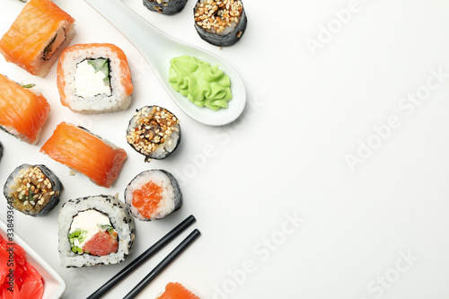Sushi rolls and chopsticks on white background, space for text. Japanese food