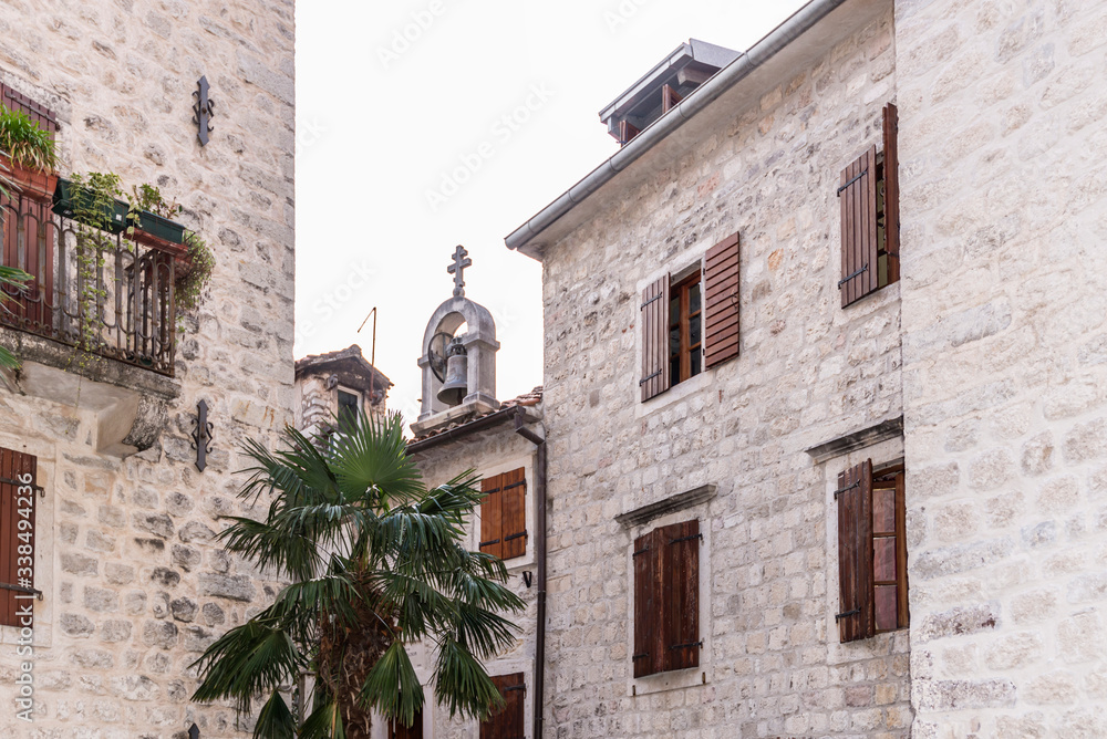 Montenegro, street in Kotor city. Holidays in Europe. View of  buildings with windows and bell