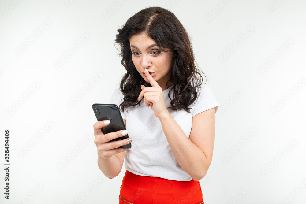 a girl with black hair sits on the Internet in social networks holding a phone in her hand and looking thoughtfully to the side a girl with black hair sits on the Internet in social networks holding a phone in her hand and looking thoughtfully to the side