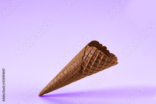 Empty  crispy  chocolate wafer cone for ice cream isolated on white.   oncept of food  treats. Mockup  template for advertising and design. Close up