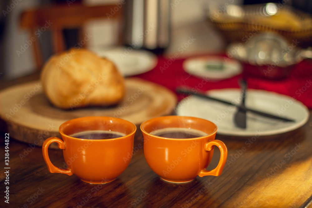 Breakfast table wood with coffee cups and hot bread. Breakfast table wood with coffee cups and hot bread.