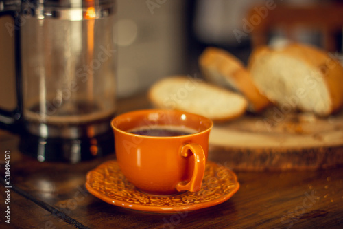 Breakfast table wood with coffee cups and hot bread.