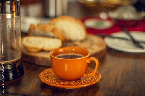 Breakfast table wood with coffee cups and hot bread.