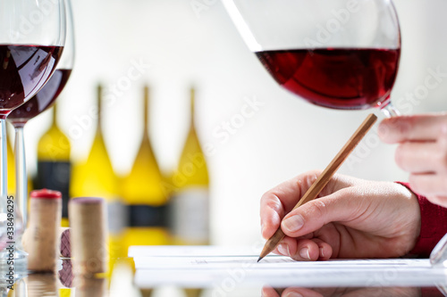 Detail of hand writing notes on wine evaluation. photo